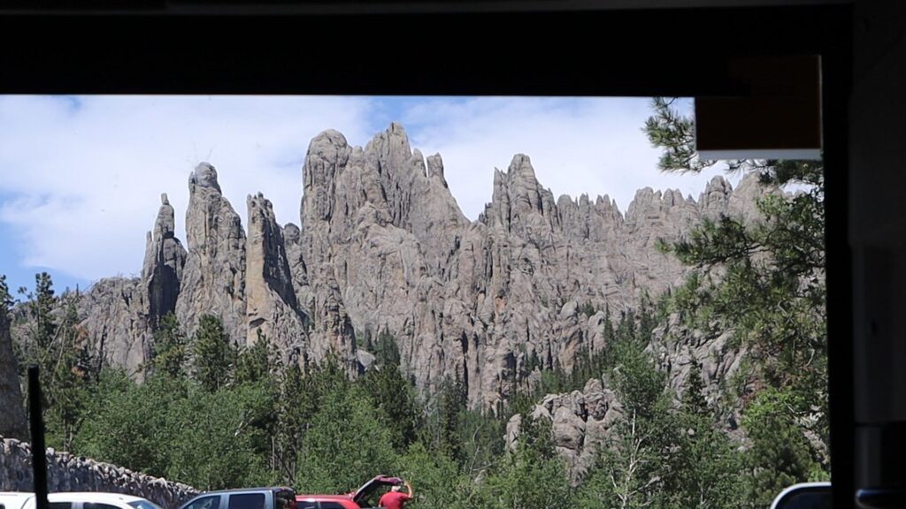 A view of a Cathedral Spires from inside a car while driving on Needles Highway at Custer State Park, South Dakota.